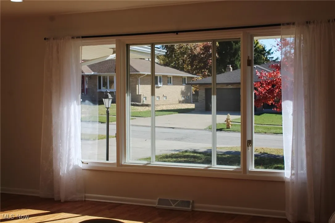 Doorway featuring baseboards and wood finished floors
