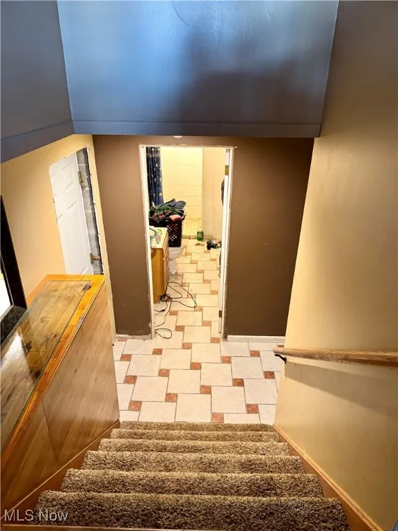 Staircase with tile patterned floors