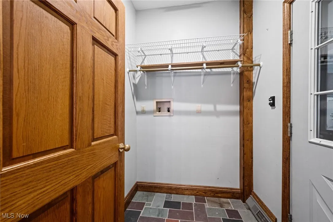 Laundry room featuring washer hookup and baseboards