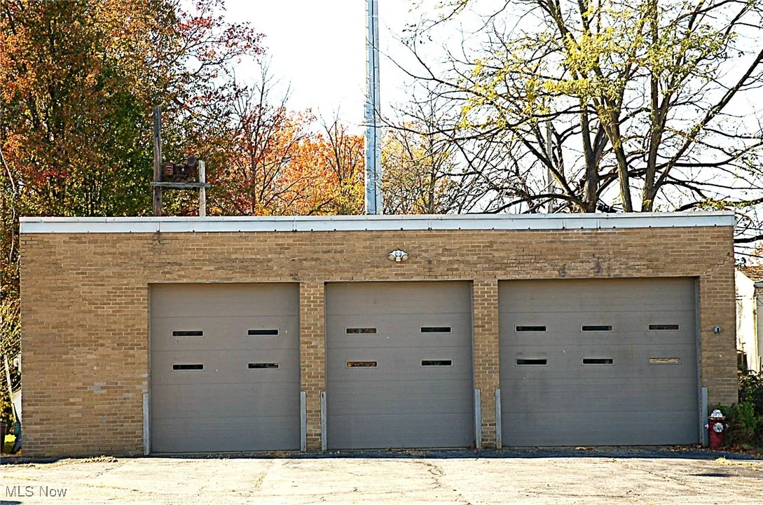 Second building (1,764 sq. ft.) at rear of lot (brick and block construction) --3 bays with 10 ft. overhead doors- 2 doors are 9ft. wide-one door is 12 ft.wide. ceilings are 14 ft high, electric and gas meters,2 side service doors.  Updates are a NEW roof (2025) newer heaters, and a newer rest room. Building with separate utilities can be rented.