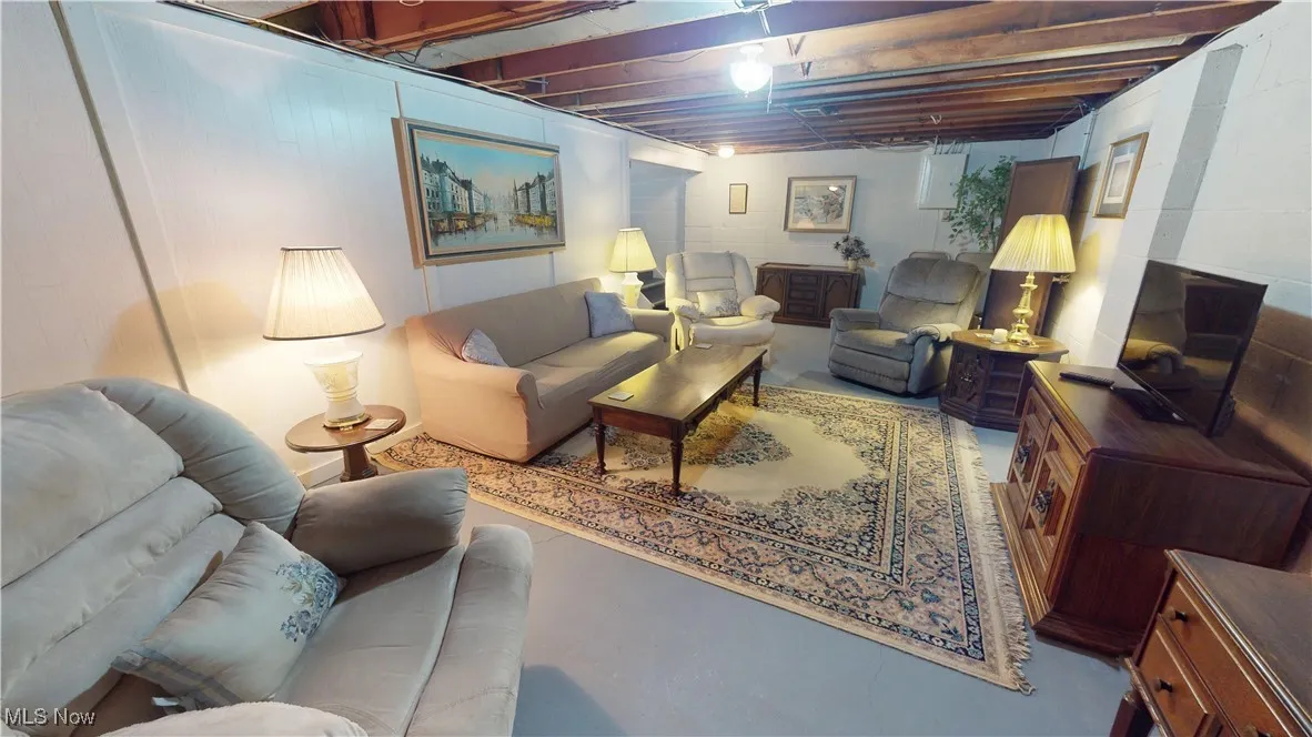 Washroom featuring finished concrete floors, independent washer and dryer, and cabinet space