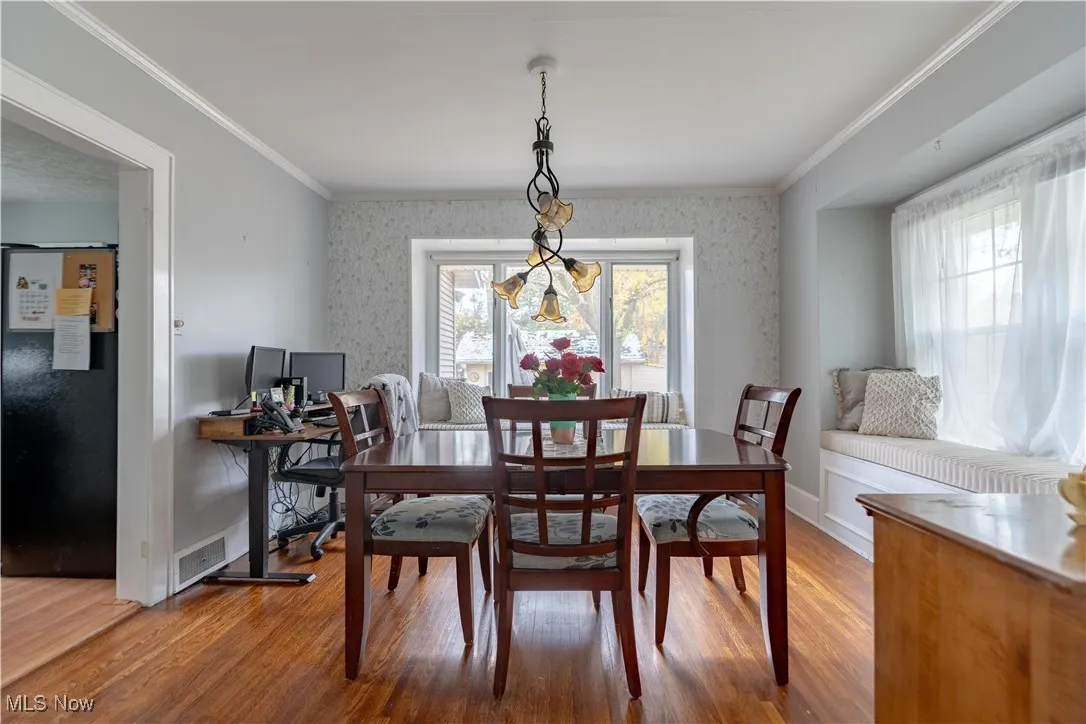 Dining room off the kitcehn with hardwood floors and lots of natural light.
