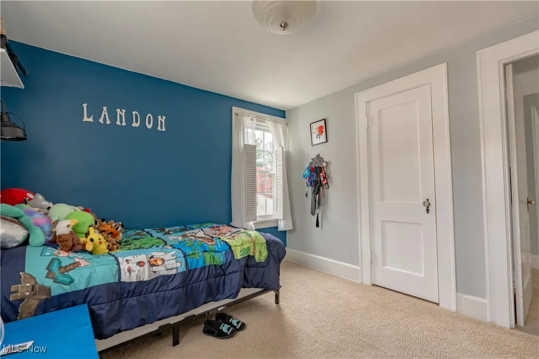 Bedroom 2 of 3 with a blue accent wall.