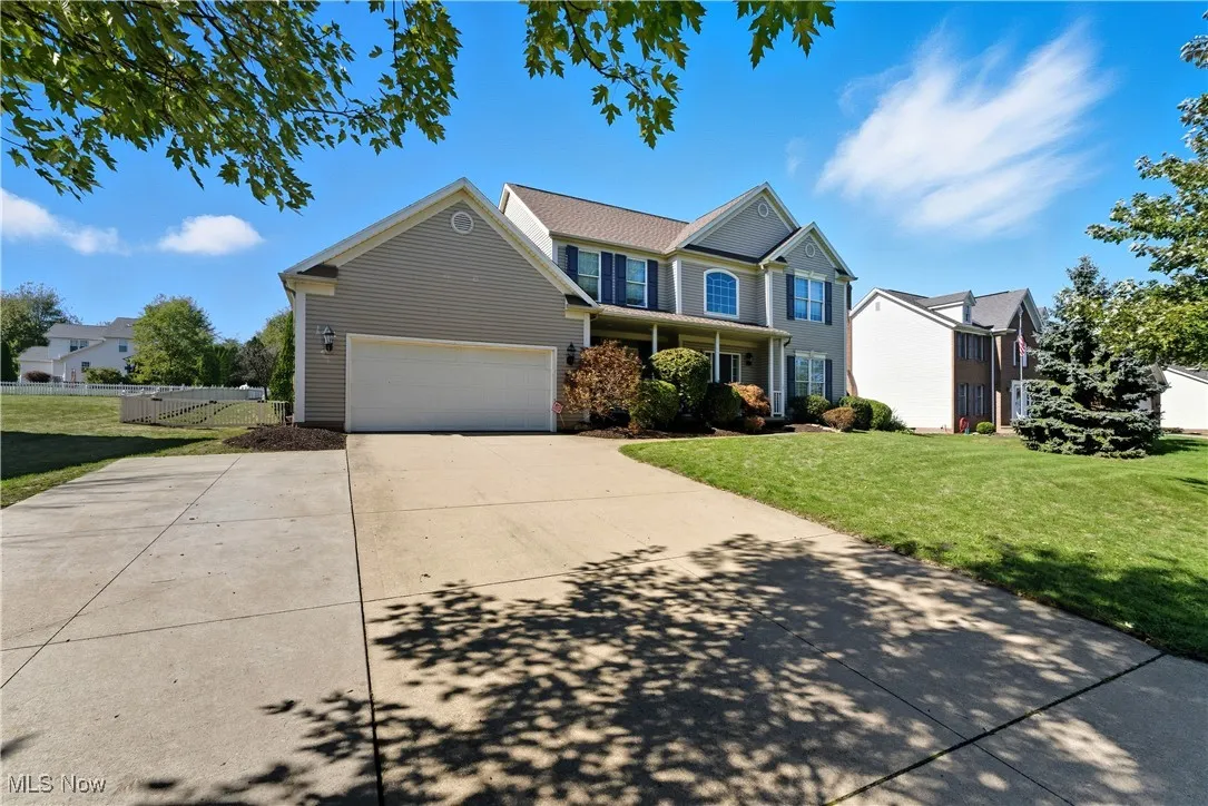 Traditional home featuring driveway and covered porch