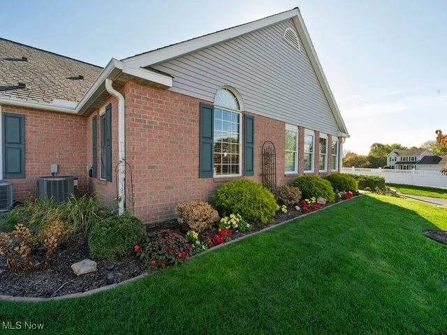 View of side of property featuring brick siding
