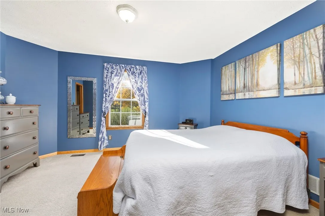 Carpeted bedroom featuring baseboards