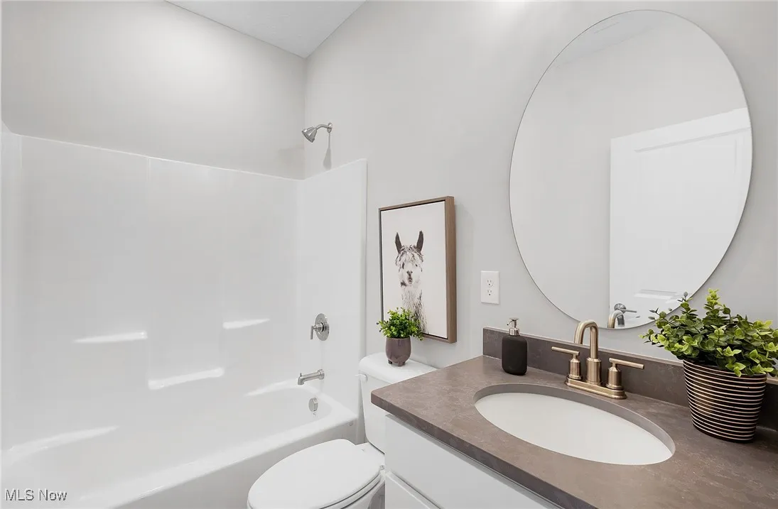 Bathroom featuring vanity and bathtub / shower combination