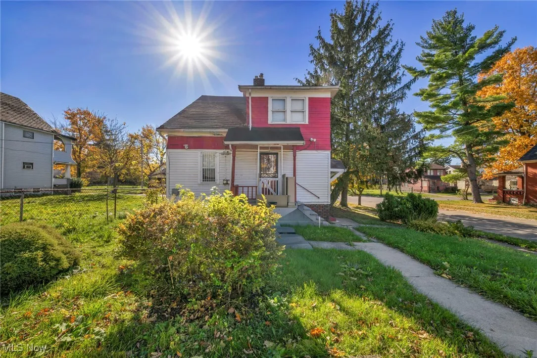 View of front facade with a chimney and covered porch