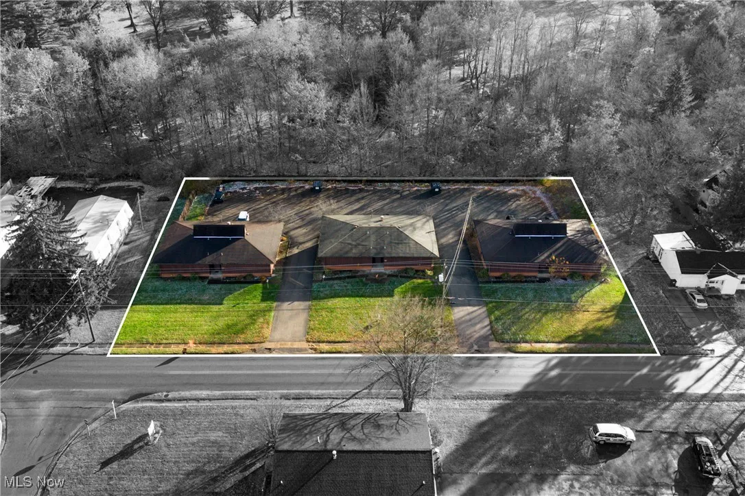 Aerial view of property and surrounding area featuring property parcel outlined