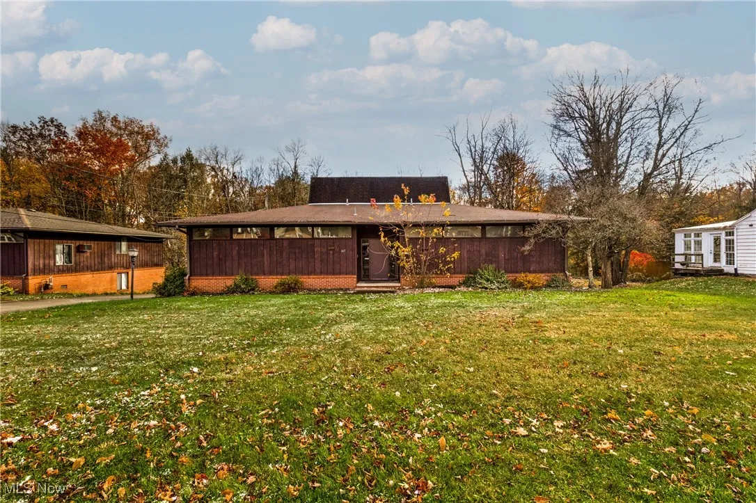 Rear view of property with a yard