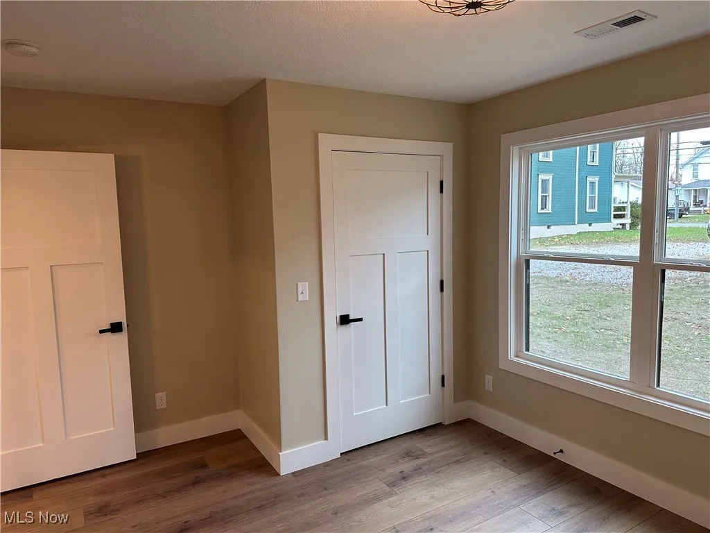 Unfurnished bedroom with LVT wood look floors