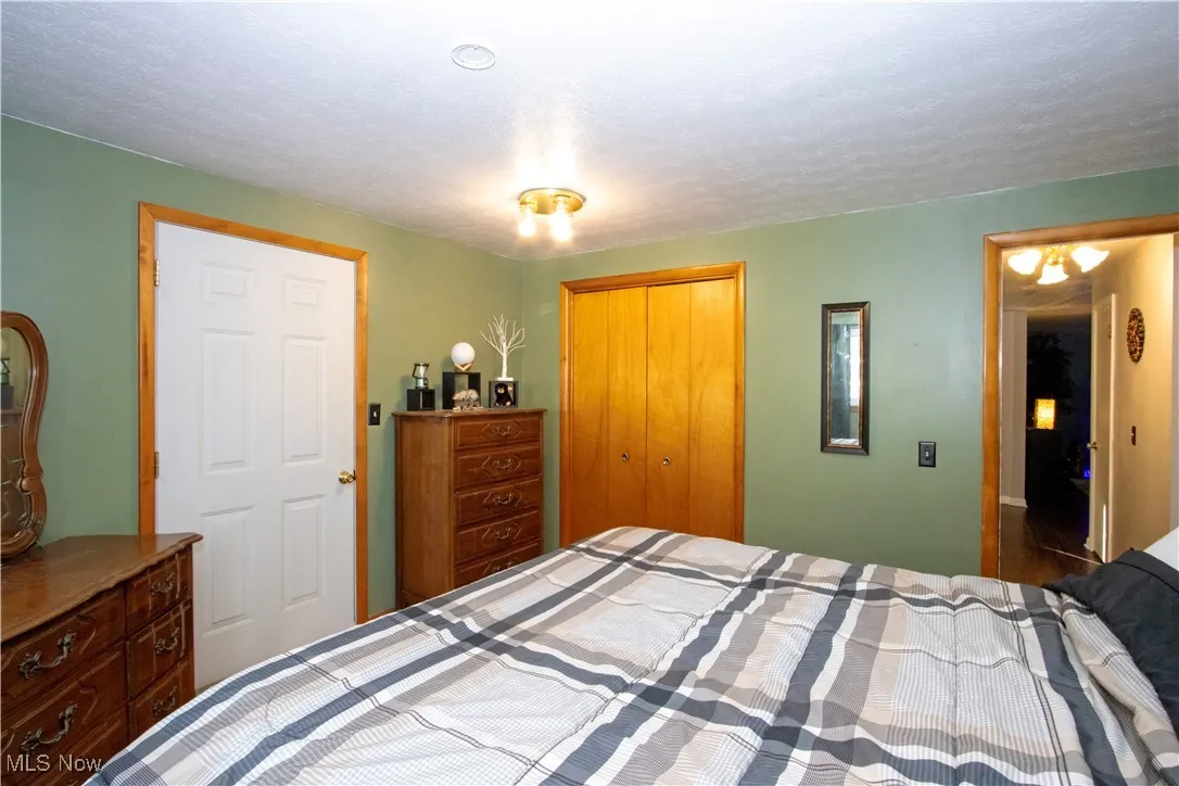 Bedroom featuring a closet and a textured ceiling
