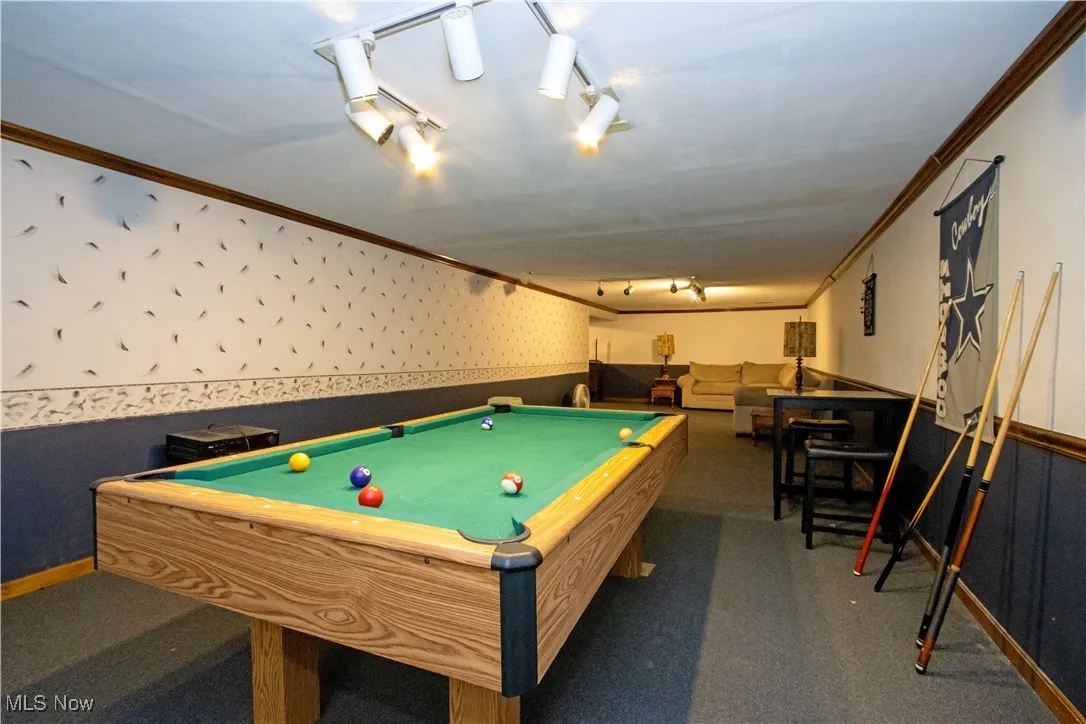 Rec room with wainscoting, wallpapered walls, billiards table, and ornamental molding