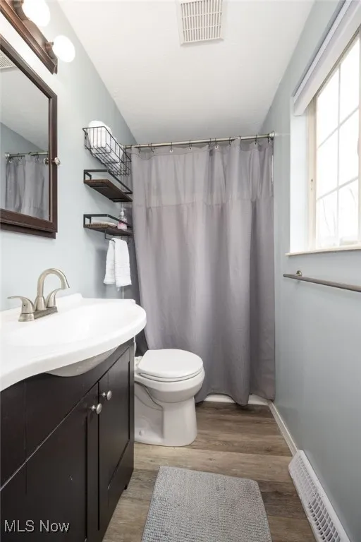 Primary bathroom with a shower, vanity and LVT flooring