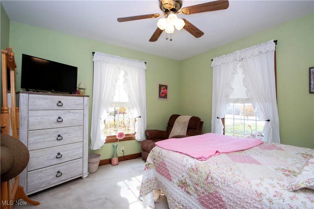 Bedroom with carpet floors and a ceiling fan