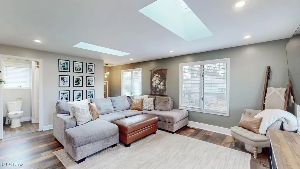 Family room features LVP flooring, lots of natural light, side door leading to fenced in area in the backyard and also located off the family room is full bathroom.