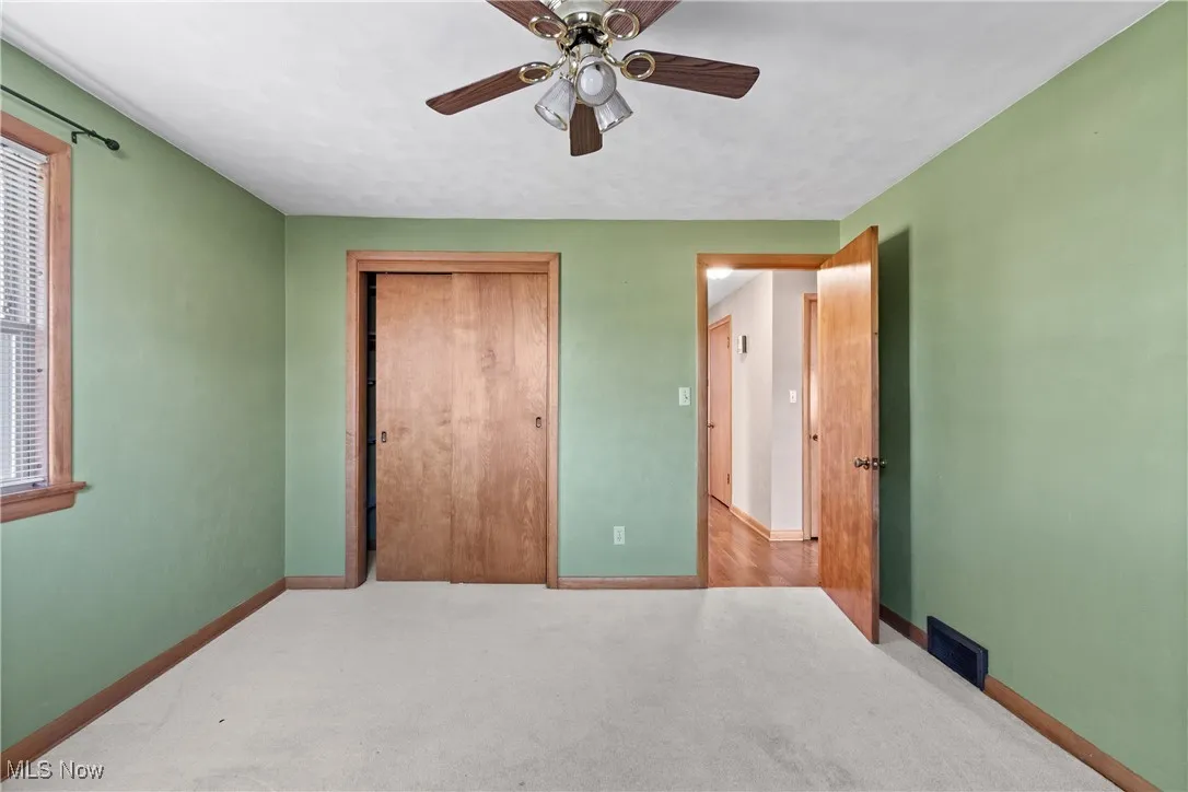 Bedroom with carpet floors, a closet, and ceiling fan
