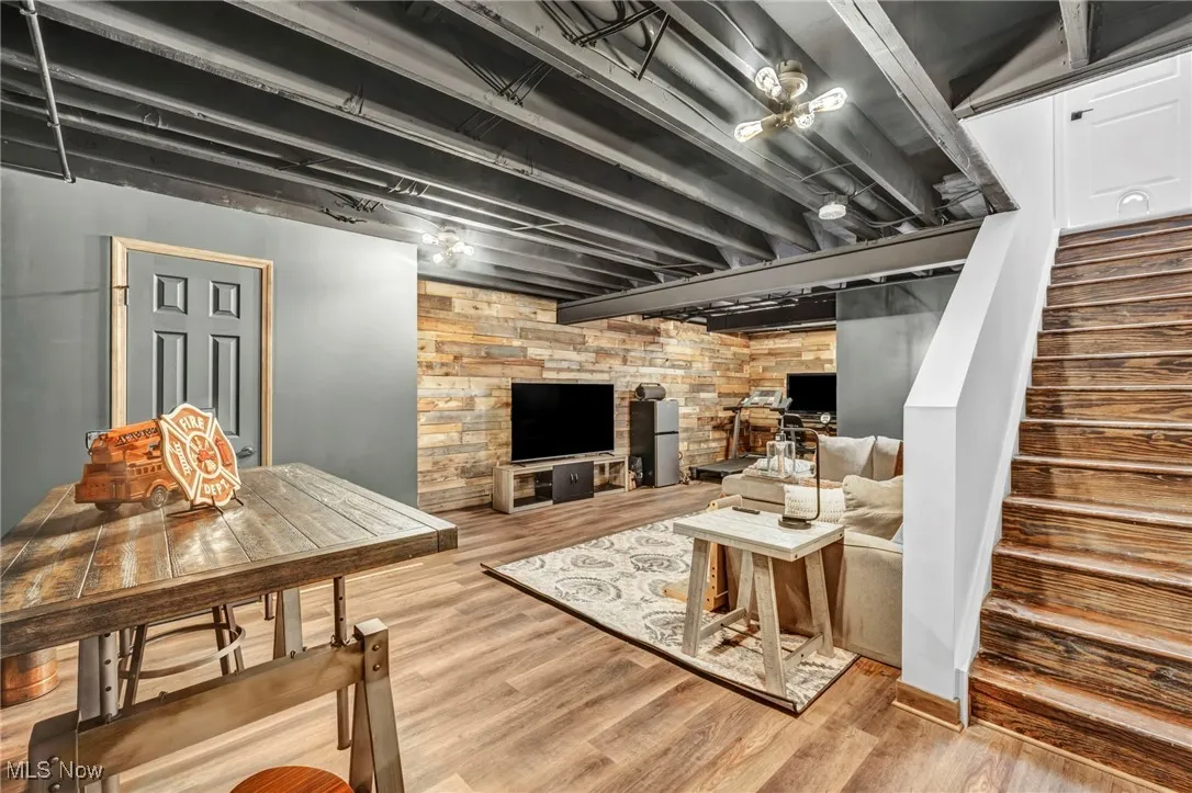 Living room featuring stairway and wood finished floors