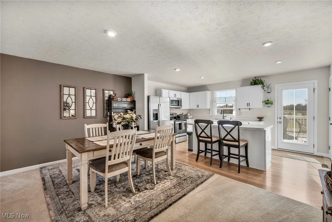 Dining area featuring recessed lighting and a textured ceiling
