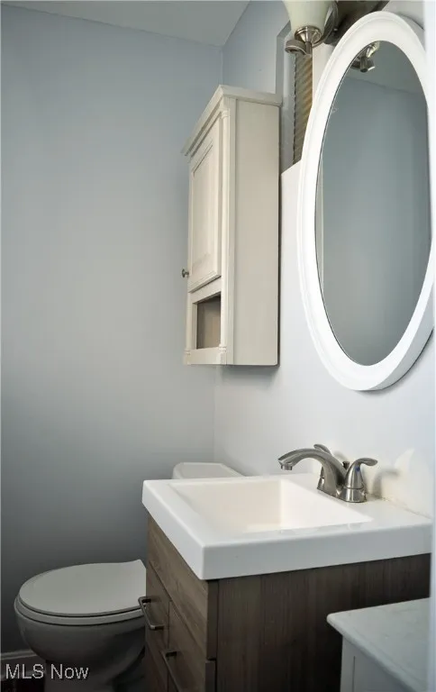 Half bath with vanity and toilet