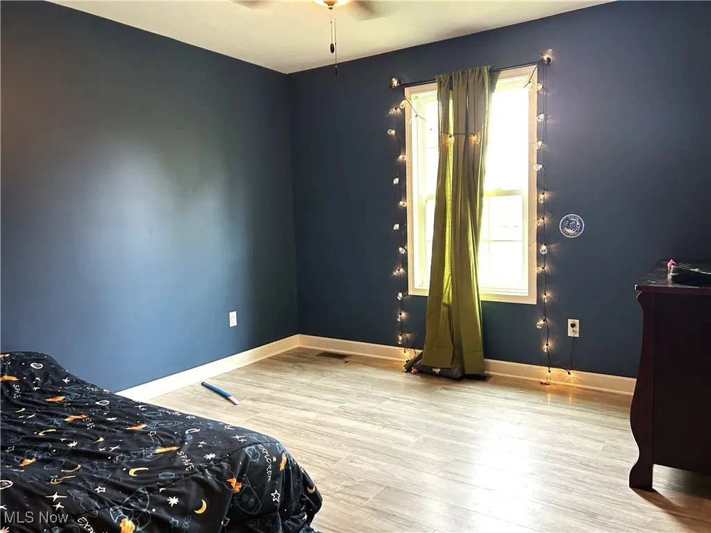 Bedroom featuring baseboards and light wood-type flooring