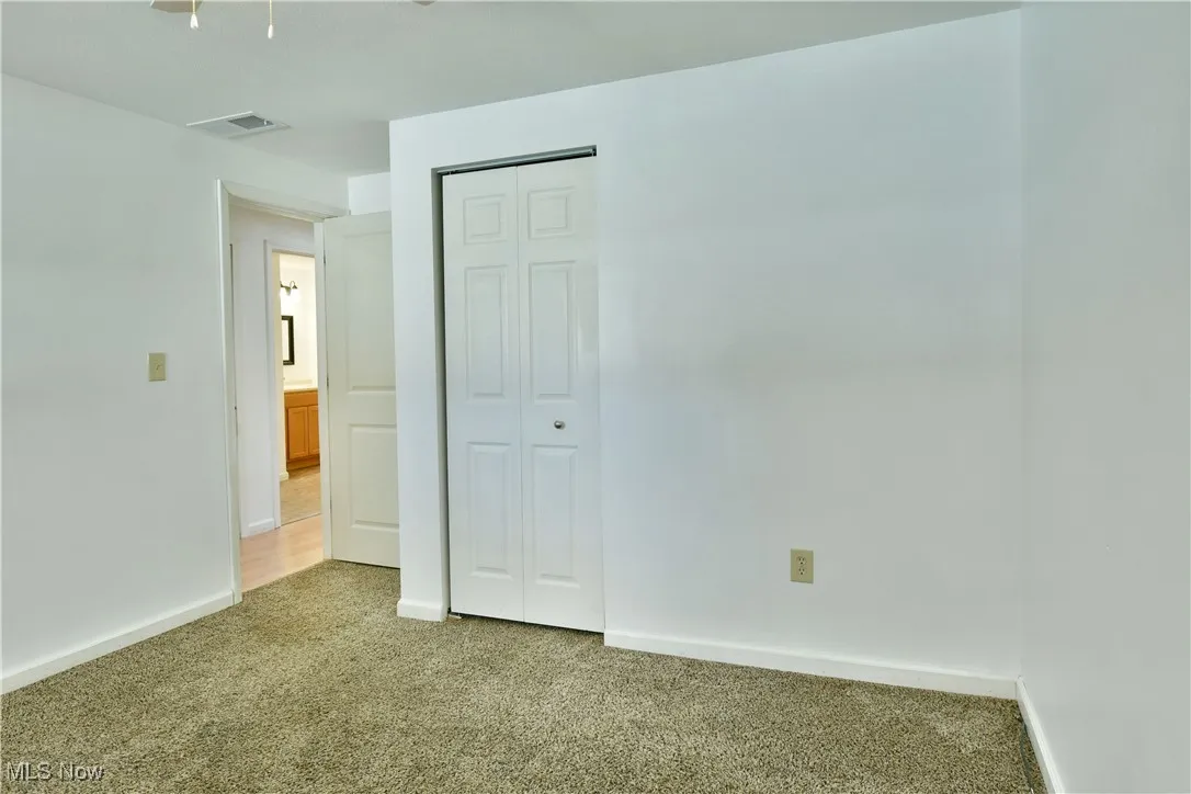 Unfurnished bedroom with carpet flooring and a closet
