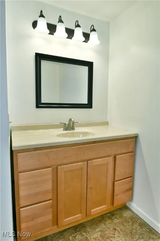 Bathroom with vanity and baseboards