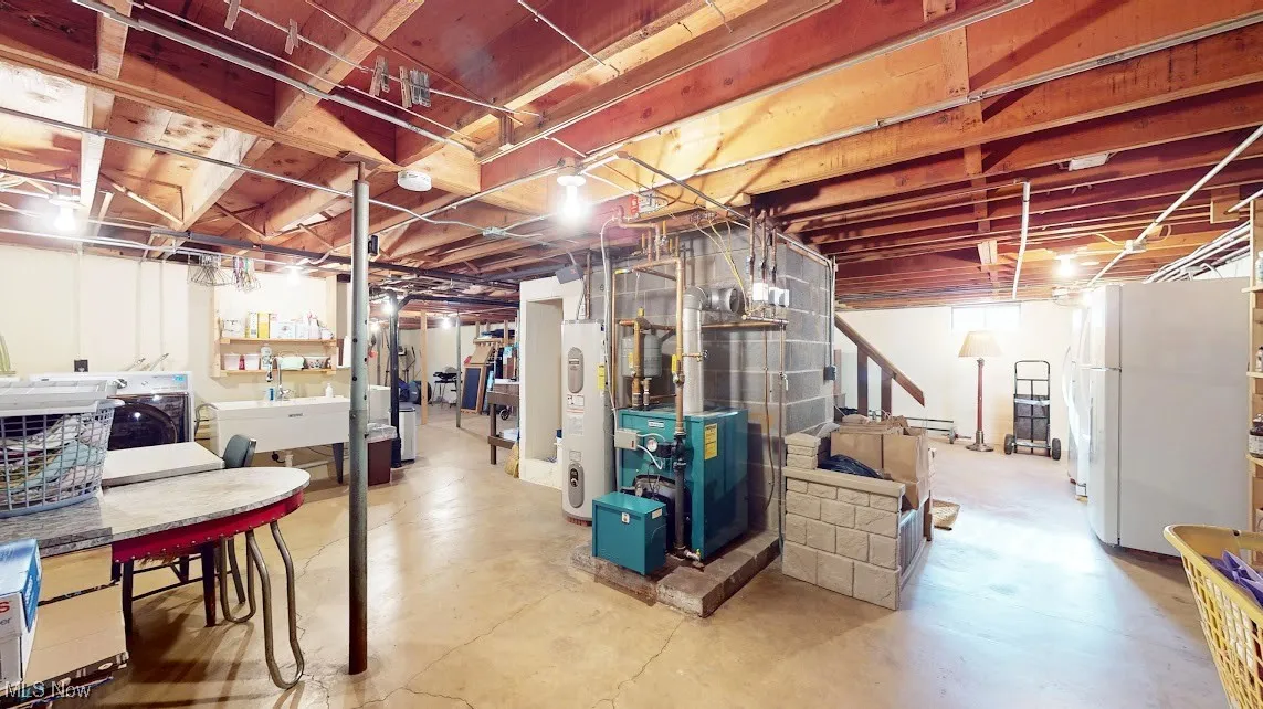 Unfinished below grade area with washer / clothes dryer