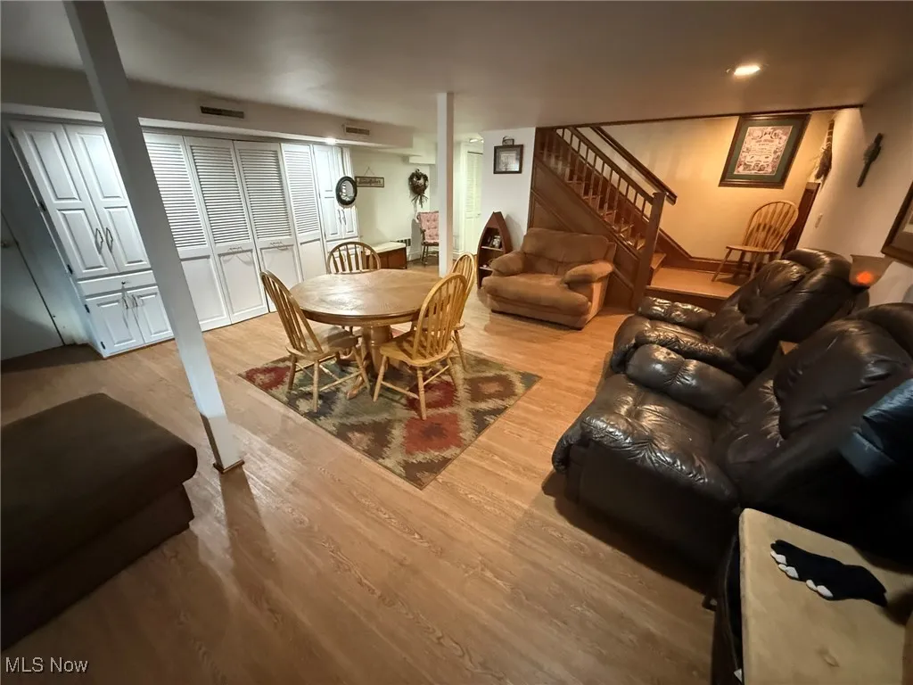 Living room featuring light wood-style floors and stairway