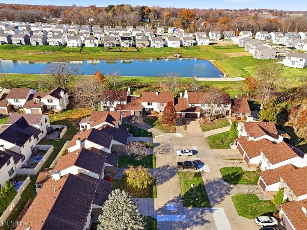 Aerial view of property's location featuring nearby suburban area and a nearby body of water