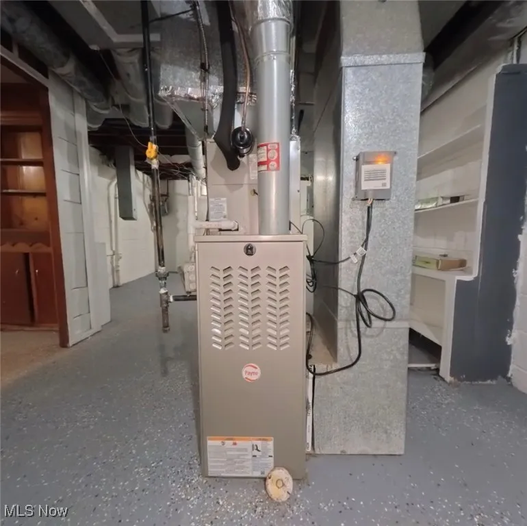 Utility room featuring heating unit