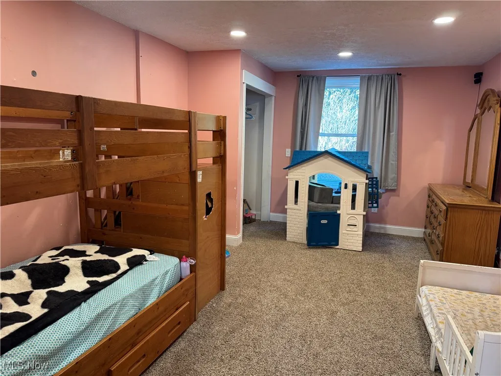 Bedroom featuring carpet floors, recessed lighting, and a textured ceiling
