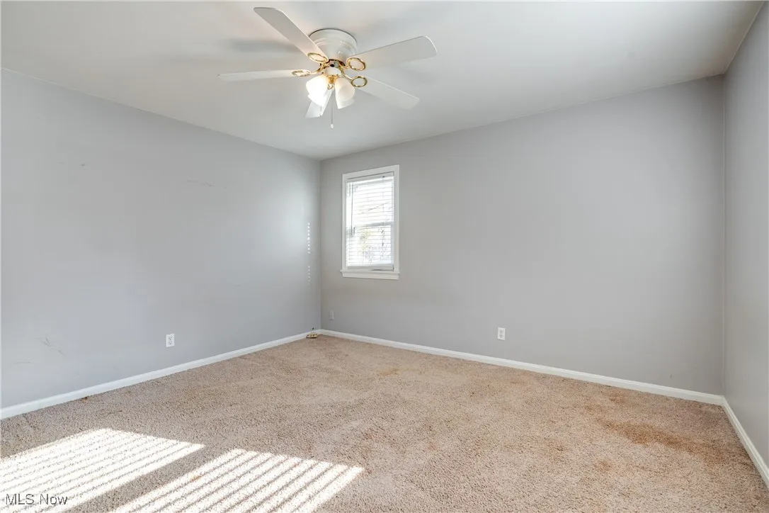 Spare room with carpet floors and ceiling fan