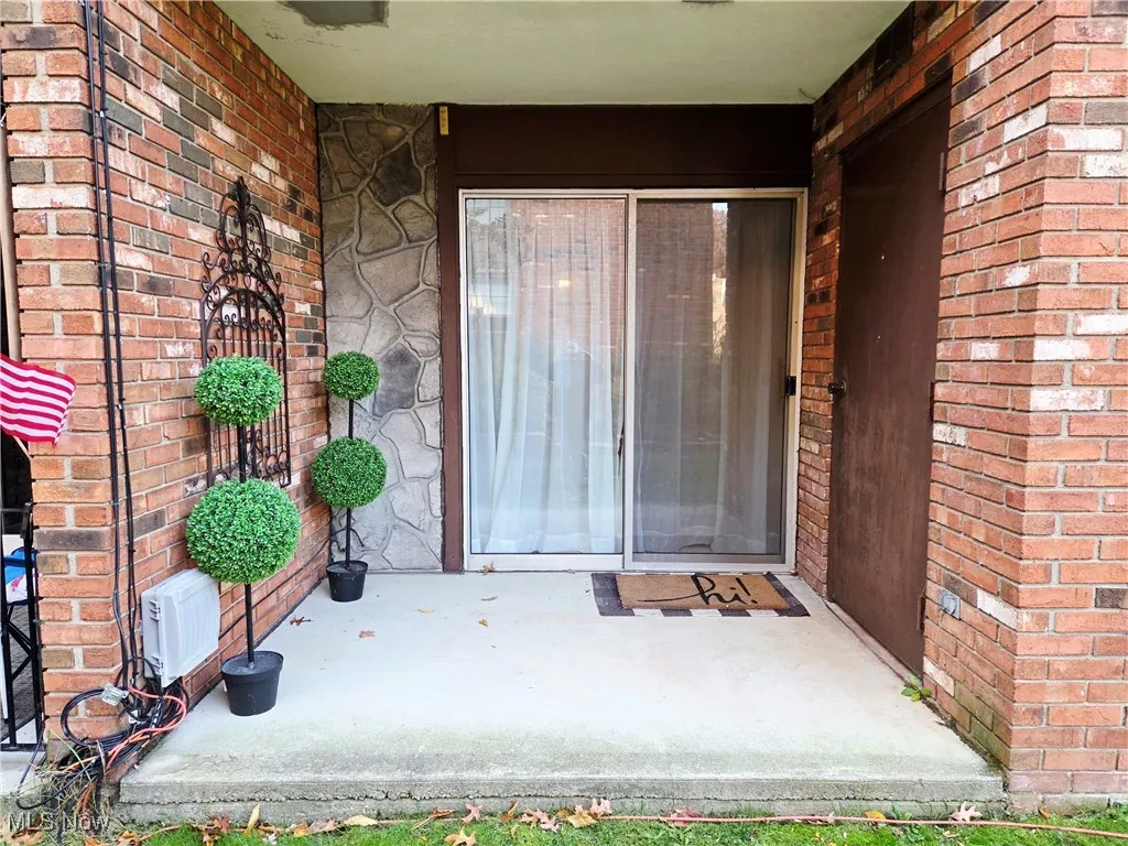 View of exterior entry with brick siding