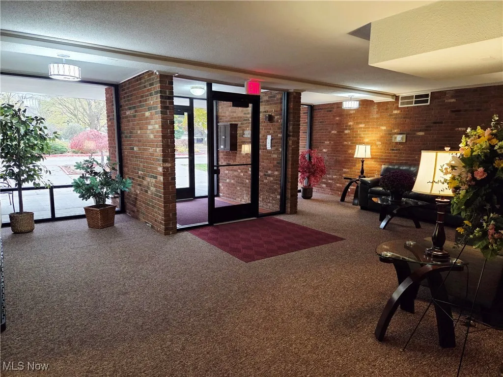 Building lobby featuring brick wall and a textured ceiling