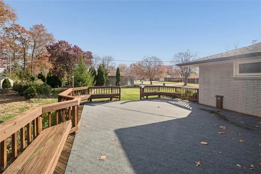 View of patio with a wooden deck
