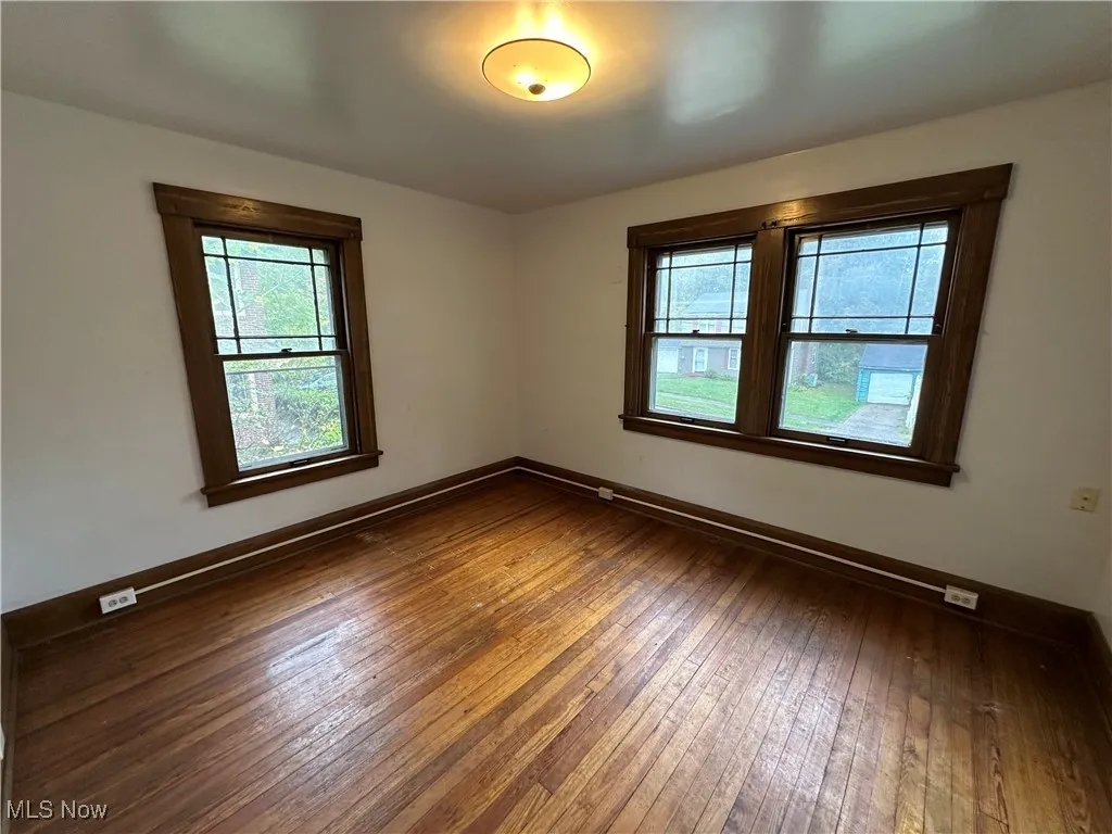 Unfurnished room featuring hardwood / wood-style floors