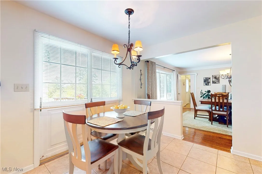 Dining room with a chandelier and light tile patterned floors