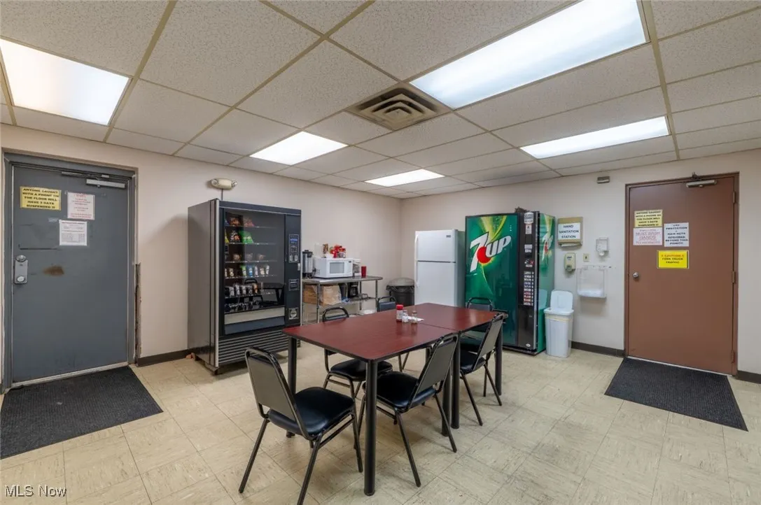 Dining space with light floors and a drop ceiling