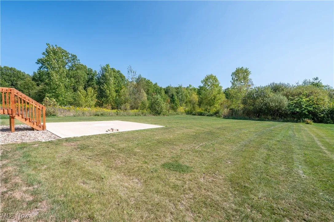 View of green lawn featuring stairway