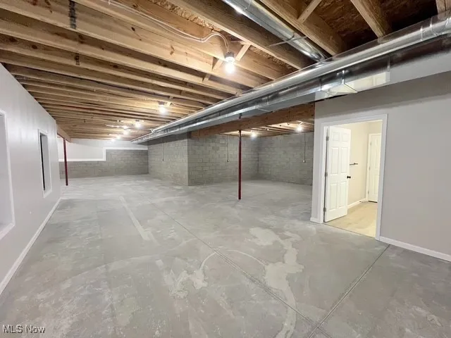 Unfinished below grade area featuring baseboards