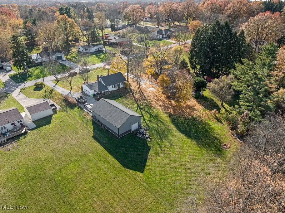 Aerial view of property's location with nearby suburban area