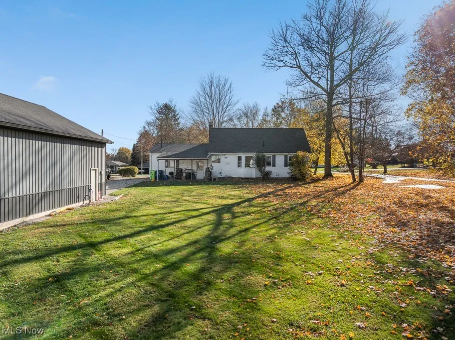 Back of property featuring a yard