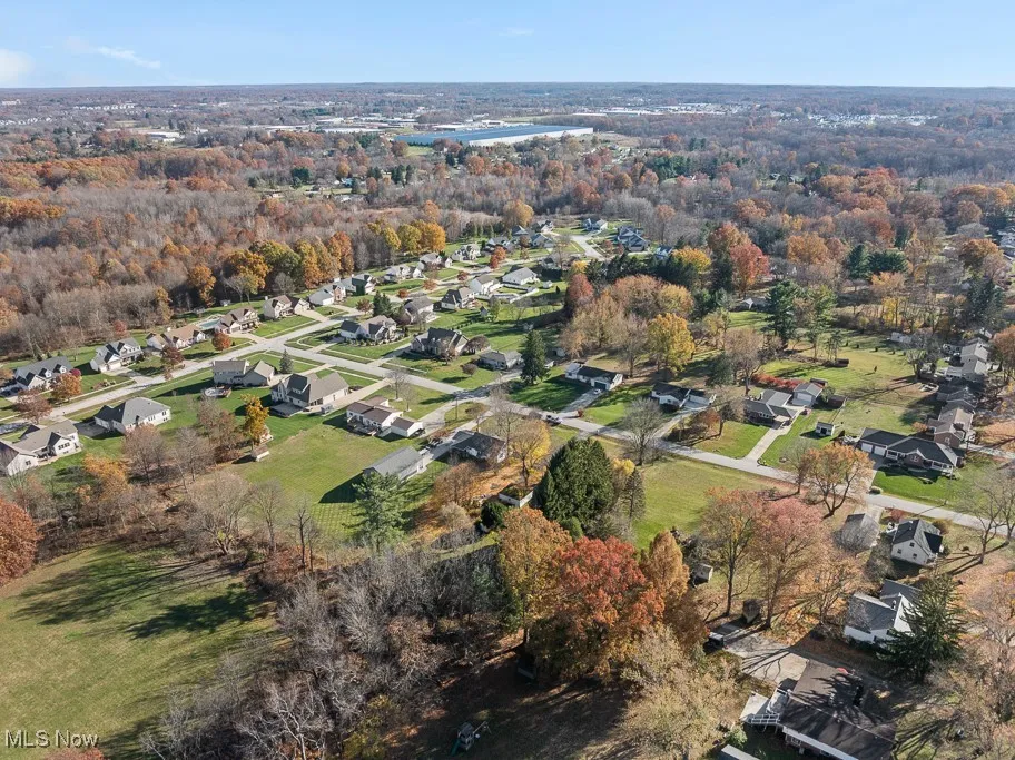 Aerial view of property's location with nearby suburban area