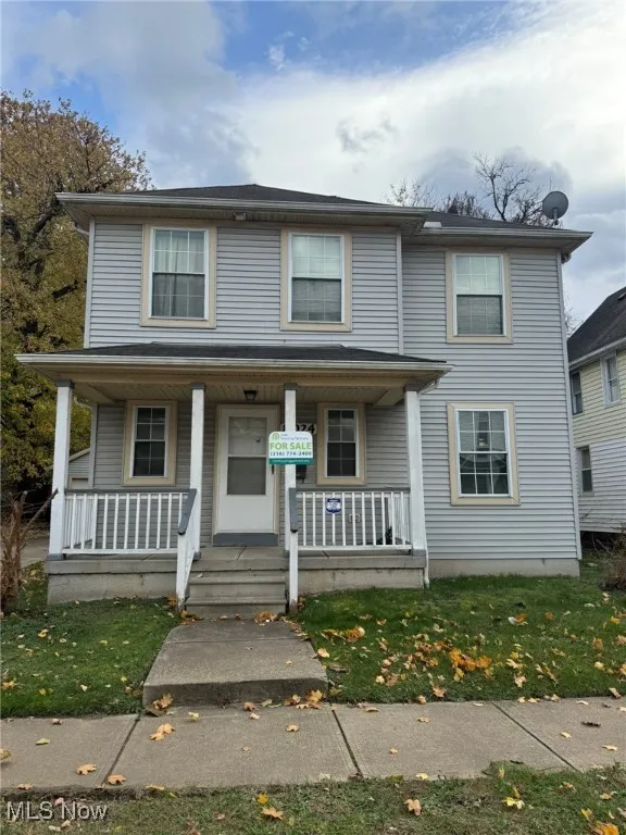 View of front of home with a porch and a front yard