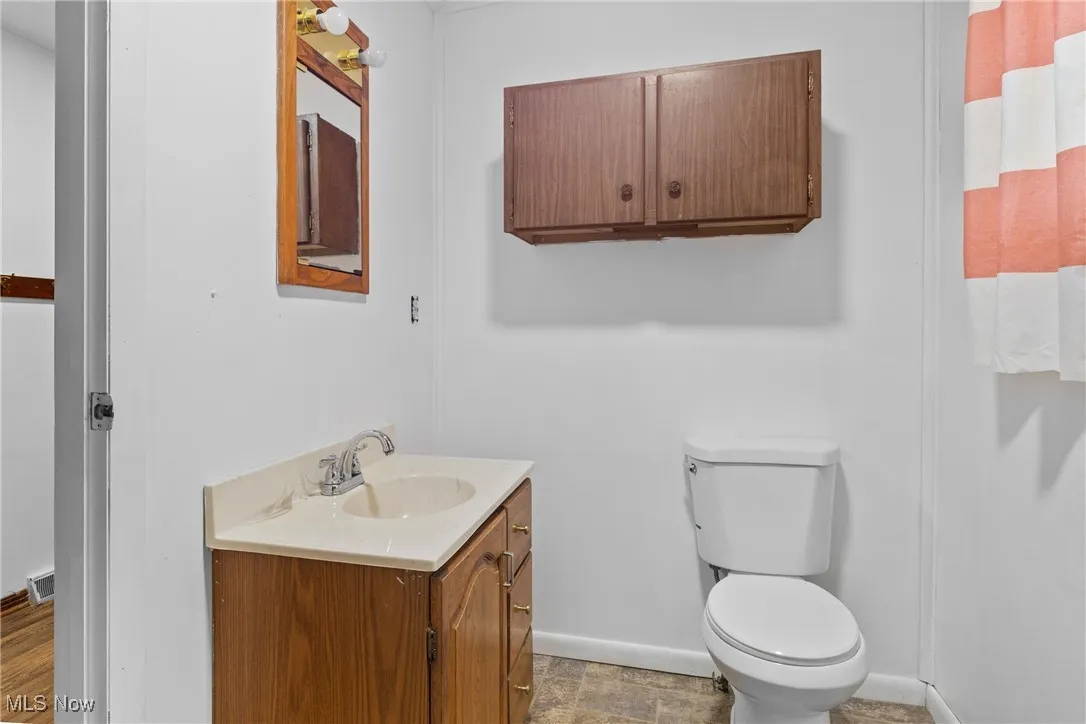 Bathroom featuring vanity and toilet