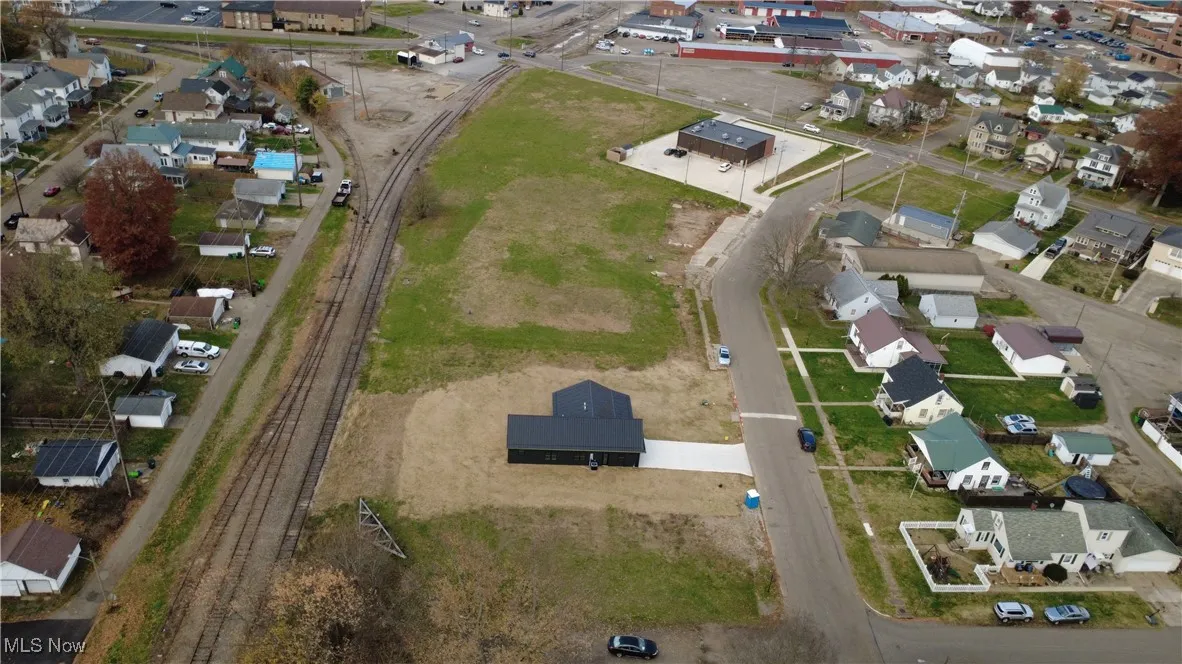 Aerial view of property's location with nearby suburban area