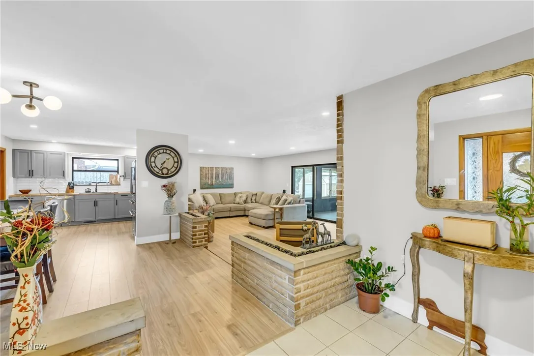 Living area featuring plenty of natural light, light wood-style flooring, and recessed lighting