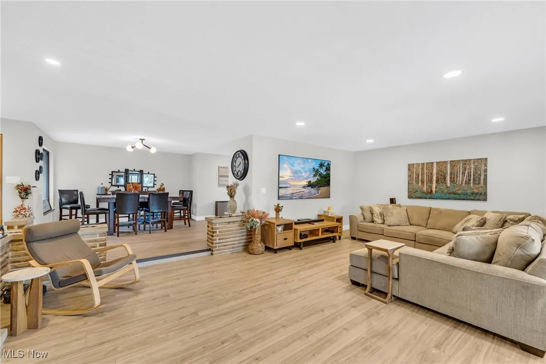 Living room with recessed lighting and light wood-type flooring