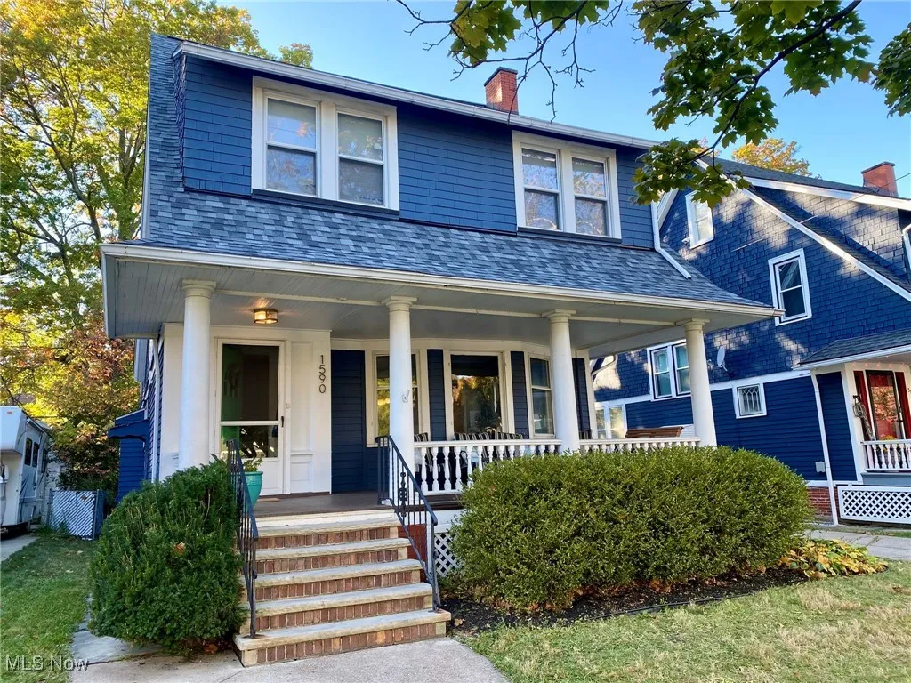 View of front of house with a porch and a chimney